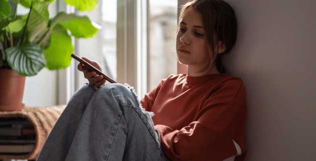 young person sat by window