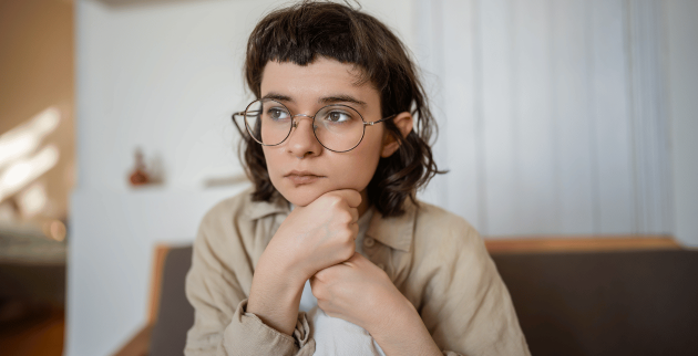 young person sat looking away from camera